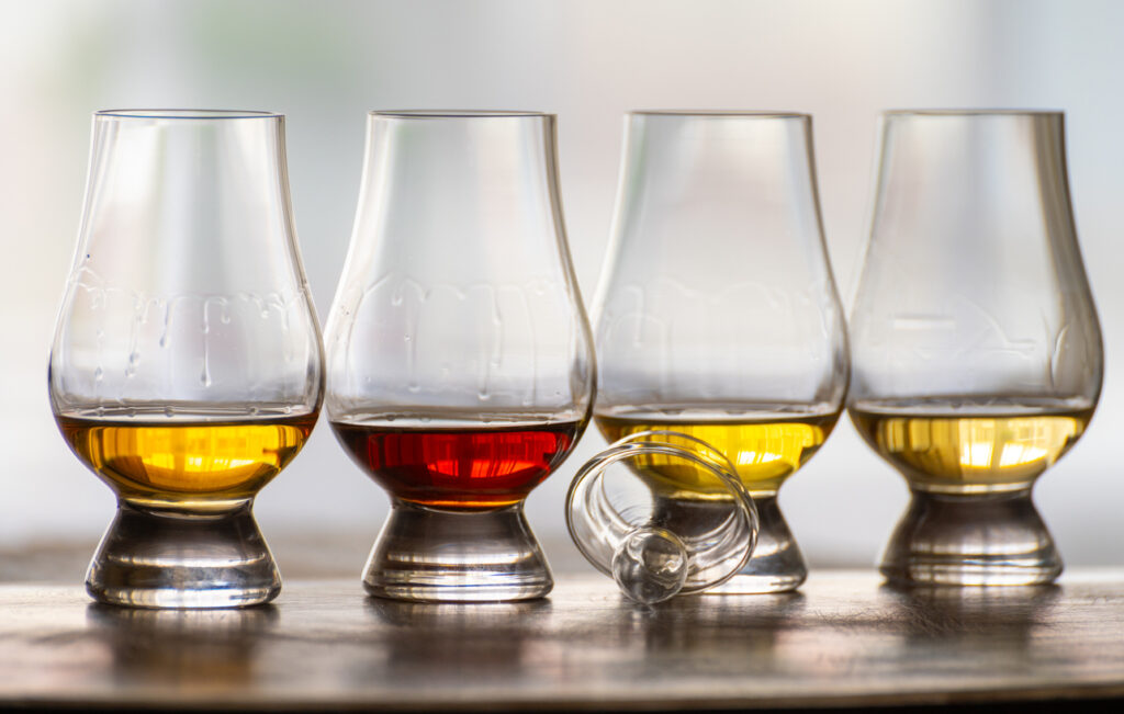 Tasting of flight of Scotch whisky from special tulip-shaped glasses on distillery in Scotland, UK